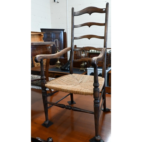 169 - A provincial beech ladderback elbow chair with rush seat