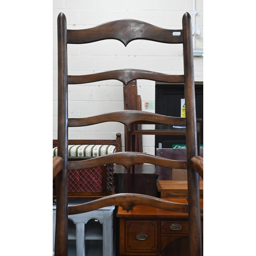 169 - A provincial beech ladderback elbow chair with rush seat