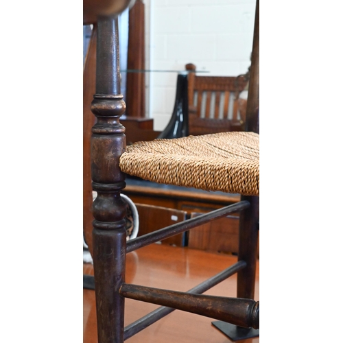 169 - A provincial beech ladderback elbow chair with rush seat