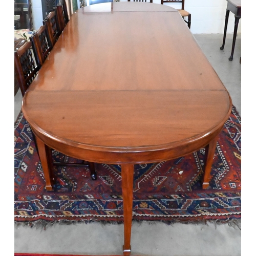 170 - A large hardwood dining table on square supports with spade feet and central rectangular section, 21... 