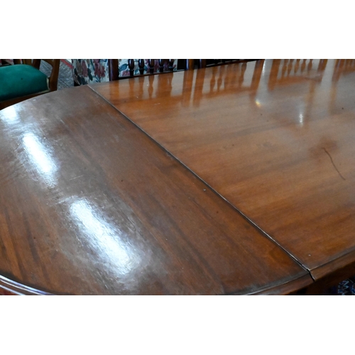 170 - A large hardwood dining table on square supports with spade feet and central rectangular section, 21... 