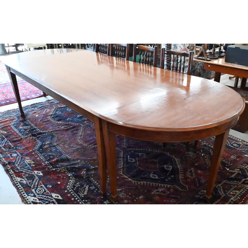 170 - A large hardwood dining table on square supports with spade feet and central rectangular section, 21... 