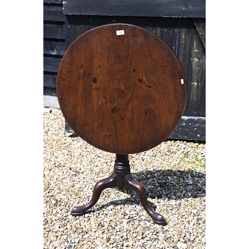 171 - A 19th century mahogany tilt-top table on gun barrel turned column and triform supports