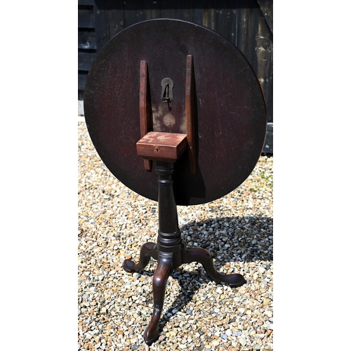 171 - A 19th century mahogany tilt-top table on gun barrel turned column and triform supports