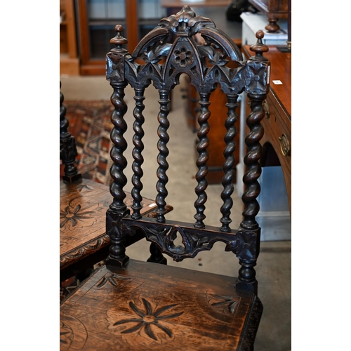 172 - A pair of late Victorian Gothic revival carved oak side chairs