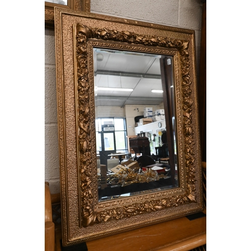 182 - A French bevelled wall mirror in moulded and textured gilt frame,80 x 60 cm to/w another foliate gil... 