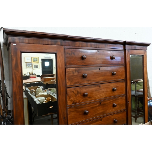 192 - A 19th century mahogany inverted breakfront compactum wardrobe with seven central drawers flanked by... 