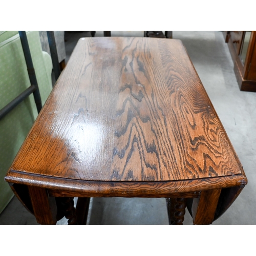 196 - #Oak drop leaf dining table on barley-twist gateleg action supports, 150 x 105 x 74 cm high