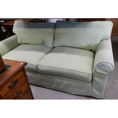 200 - A two seater scroll arm sofa, with patterned green fabric loose covers, 190 x 95 x 80 cm high