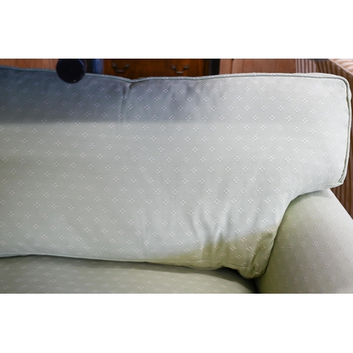 200 - A two seater scroll arm sofa, with patterned green fabric loose covers, 190 x 95 x 80 cm high