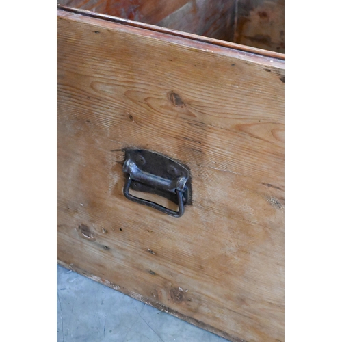 211 - An antique pine trunk with iron side handles, 92 x 60 x 58 cm high