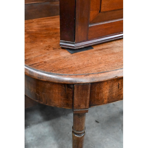 213 - A 19th century mahogany demi lune console table on turned supports and brass castors 88 x 52 x 70 cm... 