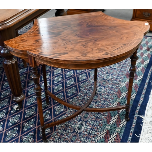 219 - An Edwardian rosewood side table with cartouche-shaped top on slender turned supports with curved st... 