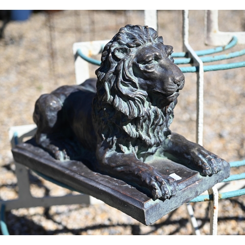 22 - A pair of Empire style bronzed composite recumbent lions, 40 cm long x 27 cm h (2)