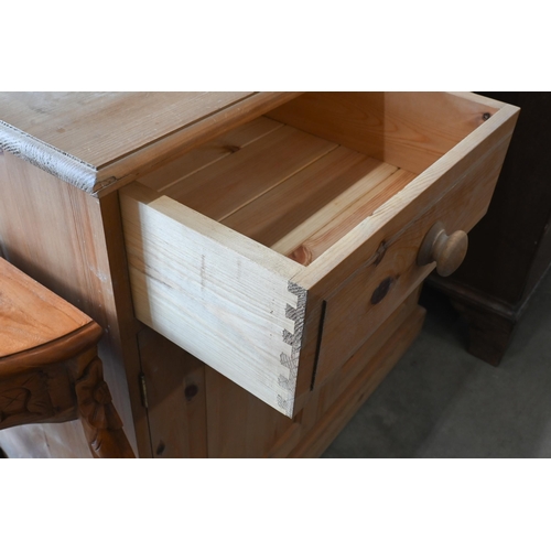 231 - A waxed pine side cabinet with two drawers over panelled cupboards, 92 x 42 x 86 cm high