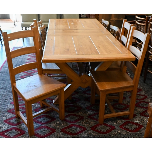 232 - A modern hardwood draw-leaf extending dining table, the cleated top opening to accept two central le... 