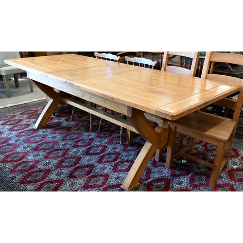 232 - A modern hardwood draw-leaf extending dining table, the cleated top opening to accept two central le... 