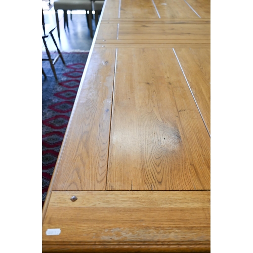 232 - A modern hardwood draw-leaf extending dining table, the cleated top opening to accept two central le... 