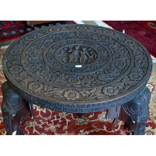 233 - An early 20th century carved hardwood Indian 'elephant' side table (A/F) 60 cm dia. x 62 cm high