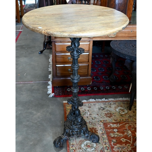 236 - A circular hardwood poseur bar/bistro table on ornate cast iron base, 68 cm dia. x 110 cm high