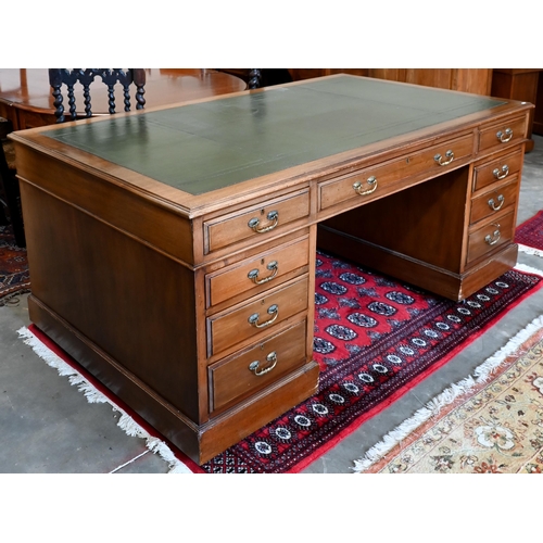 238 - An early 20th century Victorian style twin-pedestal desk with green leather top over nine drawers, 1... 