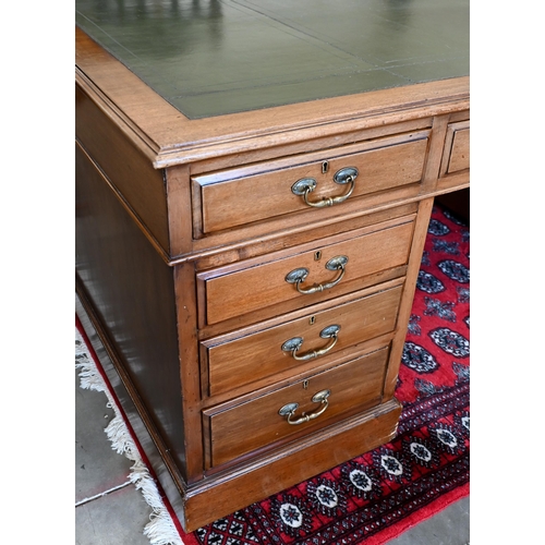 238 - An early 20th century Victorian style twin-pedestal desk with green leather top over nine drawers, 1... 