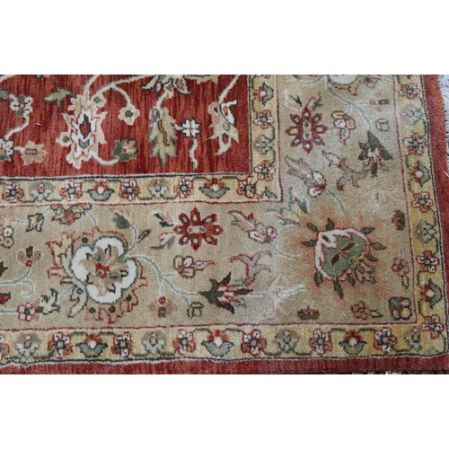 240 - An Indian Agra carpet, traditional floral design on terracotta field, beige rosette border, 274 cm x... 