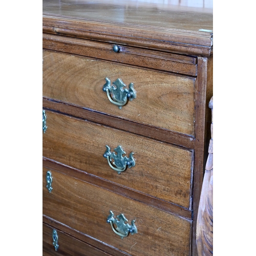 242 - A George III mahogany chest of  four long drawers below a full width brushing slide, raised on brack... 