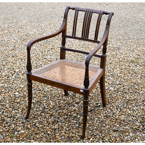 260 - A 19th century mahogany elbow chair with caned seat