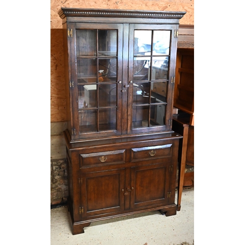 271 - A reproduction oak cabinet bookcase, the top section with astragal glazed doors enclosing shelves on... 