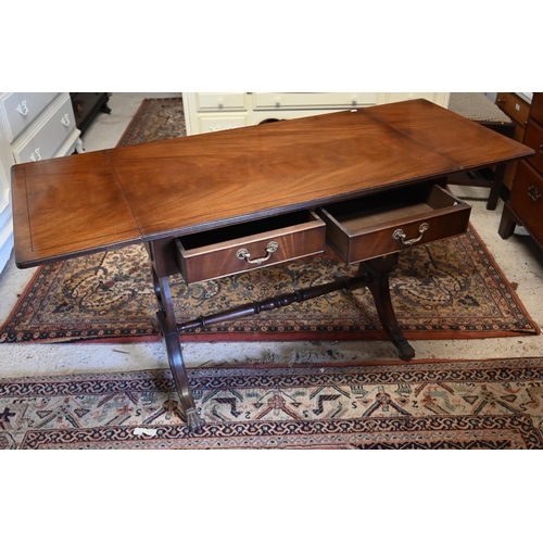 272 - A Regency style mahogany sofa table with two drawers, lyre supports and brass paw castors, 90 x 55 x... 