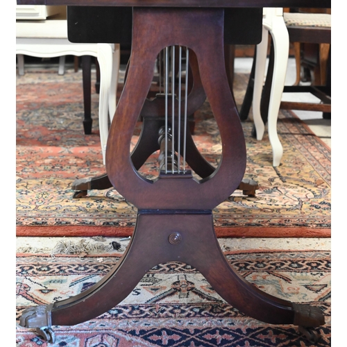 272 - A Regency style mahogany sofa table with two drawers, lyre supports and brass paw castors, 90 x 55 x... 