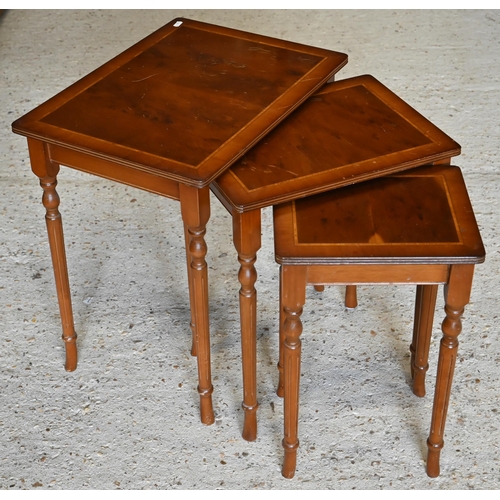 273 - Yew veneered nest of three occasional tables to/w an oval occasional table and a circular tripod lam... 