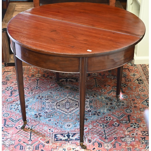 276 - #A 19th century mahogany demi-lune tea table, re-stained folding top, moulded supports and brass cas... 