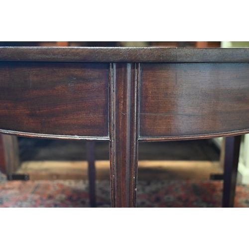 276 - #A 19th century mahogany demi-lune tea table, re-stained folding top, moulded supports and brass cas... 