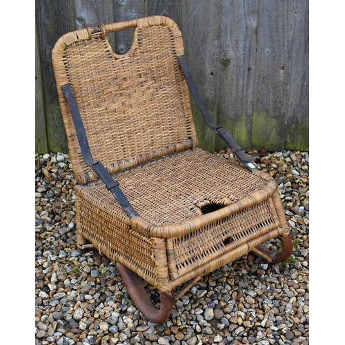 277 - A vintage 1950s rattan wicker fishing chair with folding back supports by two leather straps