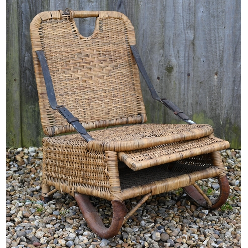 277 - A vintage 1950s rattan wicker fishing chair with folding back supports by two leather straps