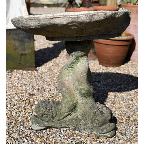 28 - A cast stone scallop shell form bird bath raised on a dolphin base, weathered, 48 cm h to/with a cas... 