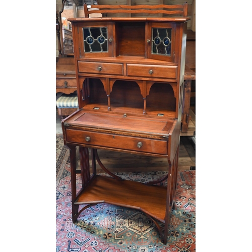 282 - A 20th century Liberty style Arts & Crafts writing desk with leaded stained glass doors, three d... 