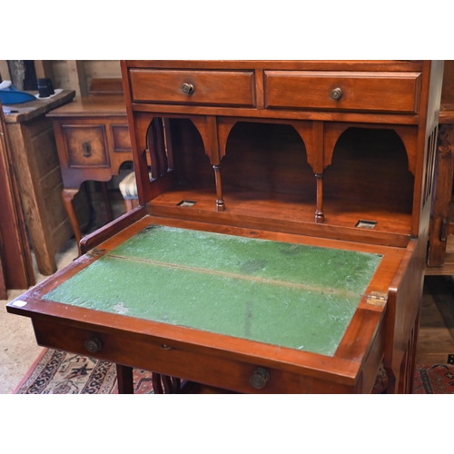 282 - A 20th century Liberty style Arts & Crafts writing desk with leaded stained glass doors, three d... 