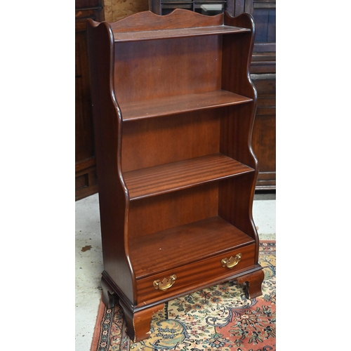 286 - A reproduction mahogany waterfall bookcase with single drawer standing on bracket feet, 58 x 30 x 11... 