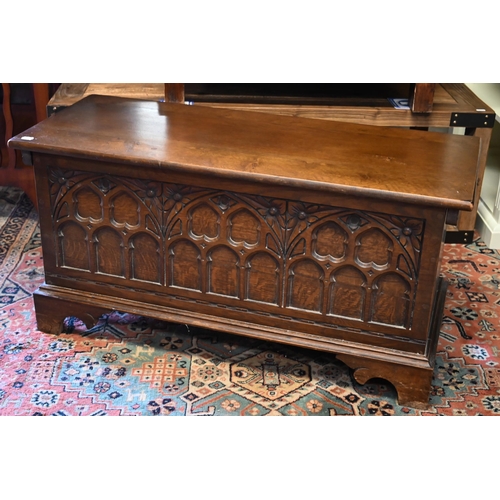 288 - A 17th century style oak coffer with Gothic arch carved front and shaped bracket feet, 94 x 40 x 46 ... 