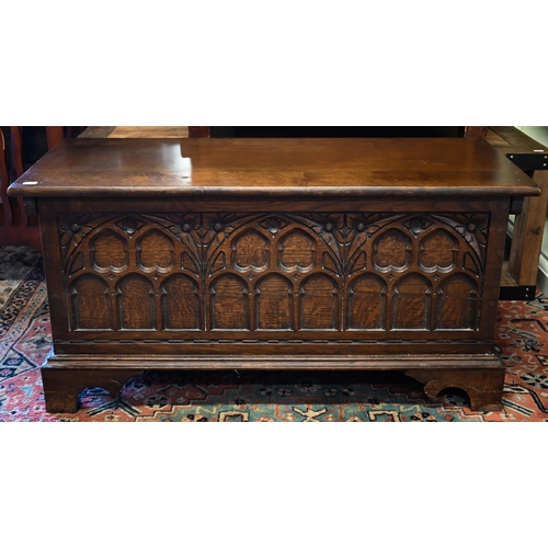 288 - A 17th century style oak coffer with Gothic arch carved front and shaped bracket feet, 94 x 40 x 46 ... 