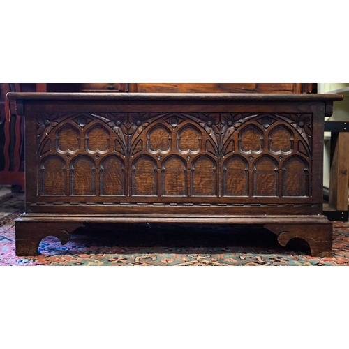 288 - A 17th century style oak coffer with Gothic arch carved front and shaped bracket feet, 94 x 40 x 46 ... 