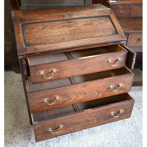 304 - An oak fall front bureau with three long graduating drawers, 90 x 54 x 96 cm