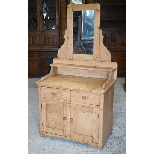 305 - #A rustic pine mirror-backed dressing chest with two drawers over panelled cupboards, 84 x 48 x 160 ... 