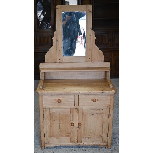 305 - #A rustic pine mirror-backed dressing chest with two drawers over panelled cupboards, 84 x 48 x 160 ... 