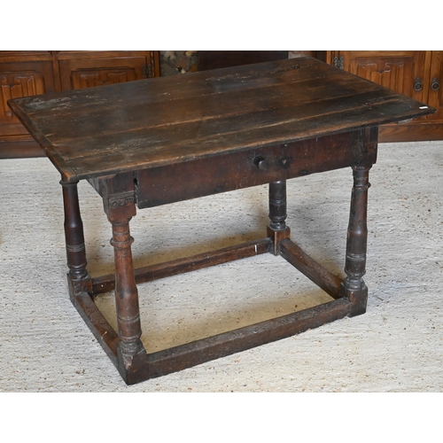 309 - A provincial 17th century oak and elm side table with cleated three-plank top over frieze drawer and... 