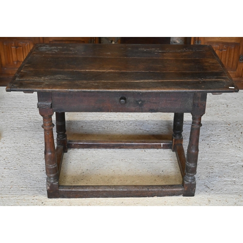 309 - A provincial 17th century oak and elm side table with cleated three-plank top over frieze drawer and... 