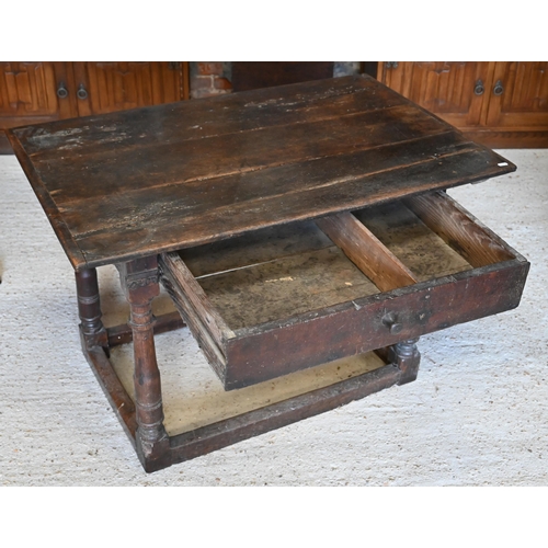 309 - A provincial 17th century oak and elm side table with cleated three-plank top over frieze drawer and... 